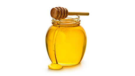 A jar of honey with a honey dipper. 
Insert your own label or logo. 
Isolated on a white background.