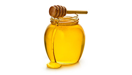 A jar of honey with a honey dipper. 
Insert your own label or logo. 
Isolated on a white background.